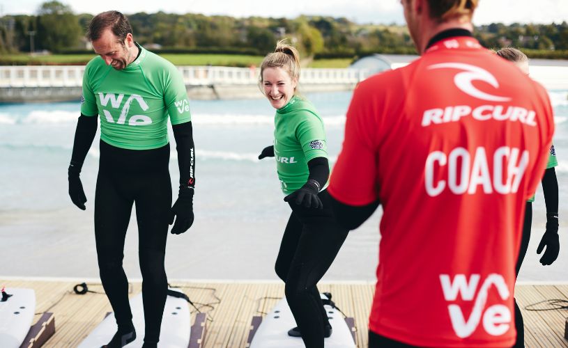 Coaches teaching students on land surfing at The Wave